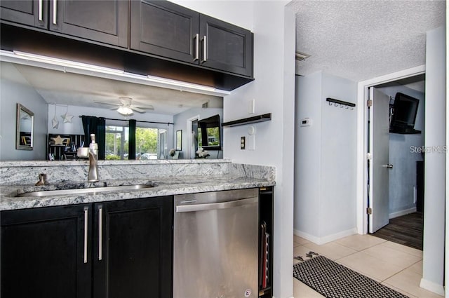 6932 Stones Throw Cir N Unit 7101, Saint Petersburg, FL 33710 - kitchen with dishwasher, dark cabinets, light tile patterned floors, a ceiling fan, and a textured ceiling