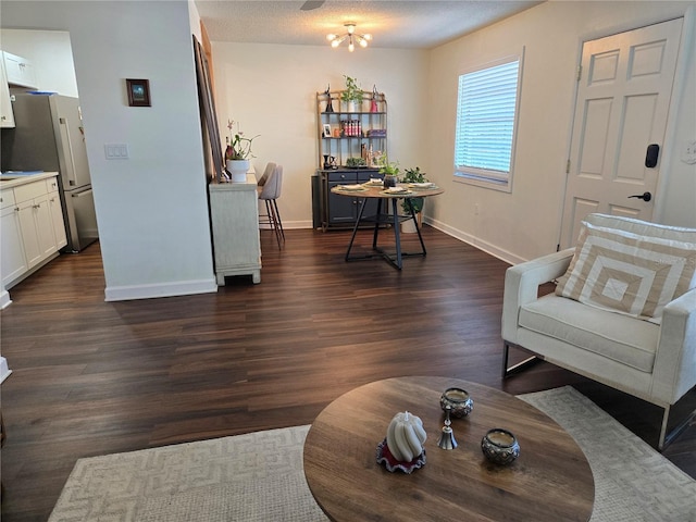 5925 Terrace Park Dr N Unit 210, Saint Petersburg, FL 33709 - living room featuring baseboards and dark wood-style flooring