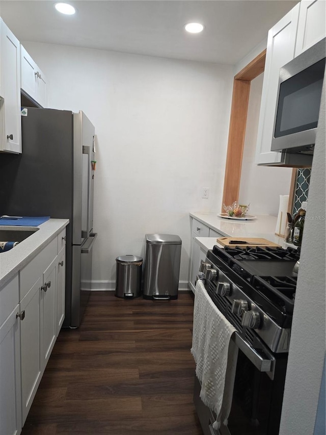 5925 Terrace Park Dr N Unit 210, Saint Petersburg, FL 33709 - kitchen featuring appliances with stainless steel finishes, dark wood-style flooring, light countertops, white cabinets, and recessed lighting