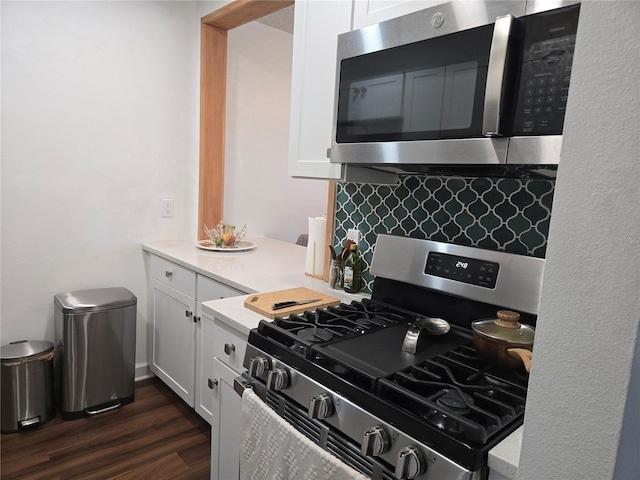 5925 Terrace Park Dr N Unit 210, Saint Petersburg, FL 33709 - kitchen featuring stainless steel appliances, backsplash, white cabinetry, and light countertops
