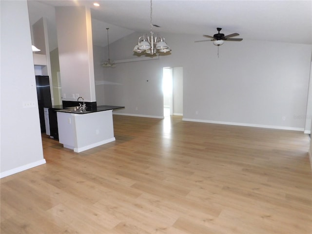 2114 Intervista Ln, Valrico, FL 33594 - unfurnished living room with ceiling fan, high vaulted ceiling, a chandelier, and light wood-style flooring