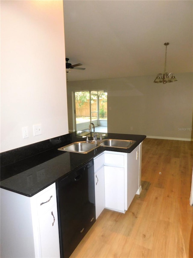 2114 Intervista Ln, Valrico, FL 33594 - kitchen with dishwasher, a peninsula, dark countertops, white cabinets, and light wood-style floors