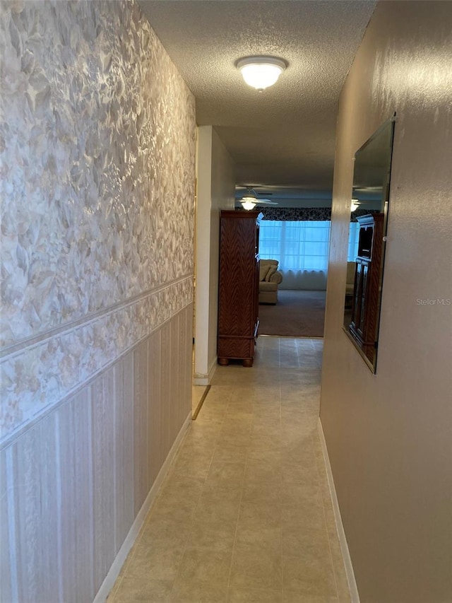 5623 80th St N Unit 314, Saint Petersburg, FL 33709 - hallway featuring a textured ceiling and baseboards