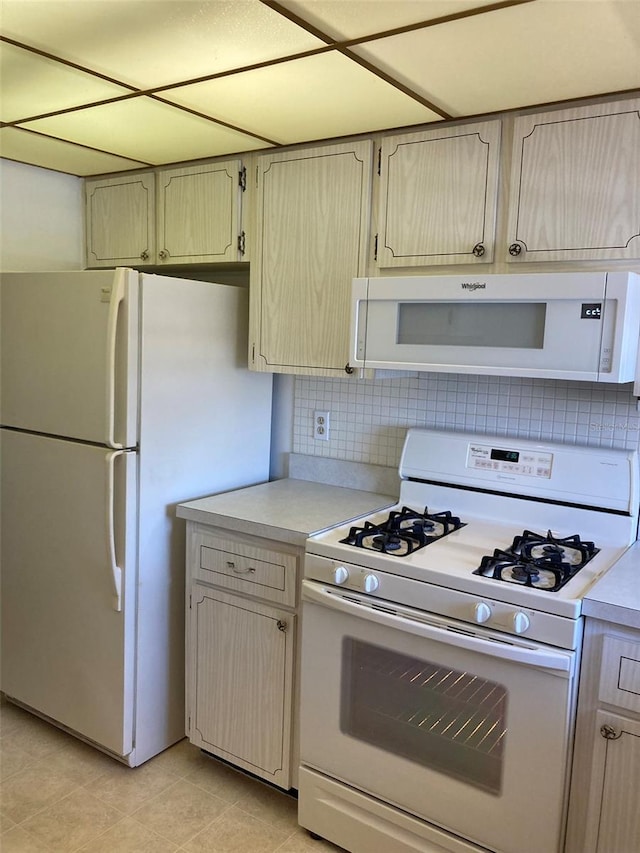 5623 80th St N Unit 314, Saint Petersburg, FL 33709 - kitchen featuring white appliances, light countertops, tasteful backsplash, and light tile patterned floors
