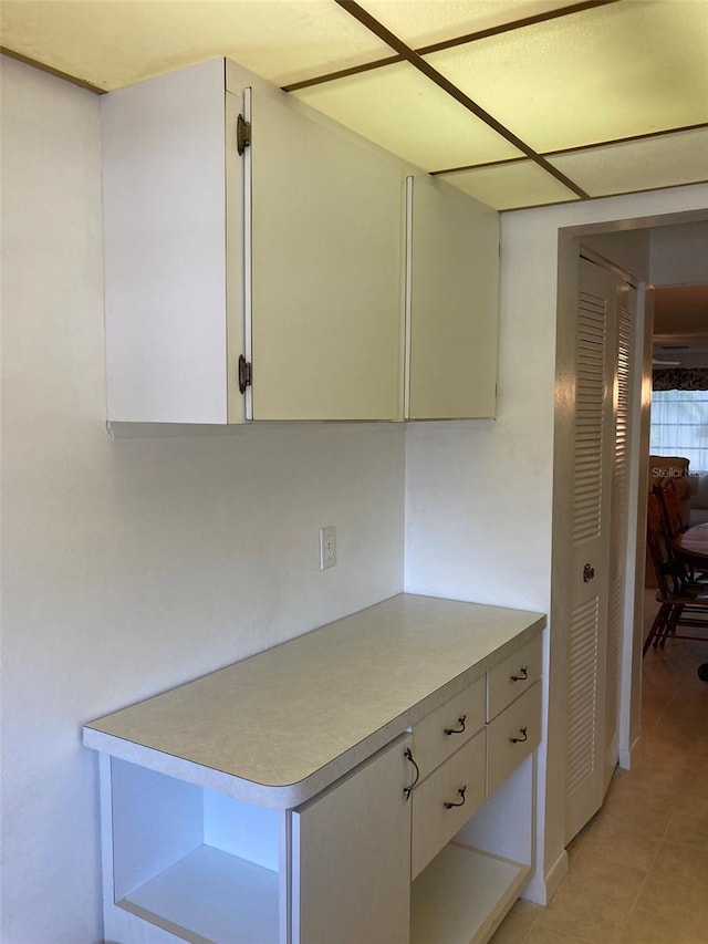 5623 80th St N Unit 314, Saint Petersburg, FL 33709 - kitchen featuring light countertops, light tile patterned floors, and white cabinetry