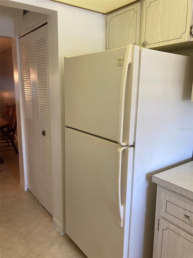 5623 80th St N Unit 314, Saint Petersburg, FL 33709 - kitchen featuring freestanding refrigerator, light countertops, and cream cabinetry