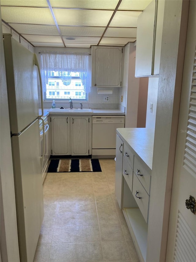 5623 80th St N Unit 314, Saint Petersburg, FL 33709 - kitchen featuring white appliances, light countertops, decorative backsplash, and light tile patterned floors