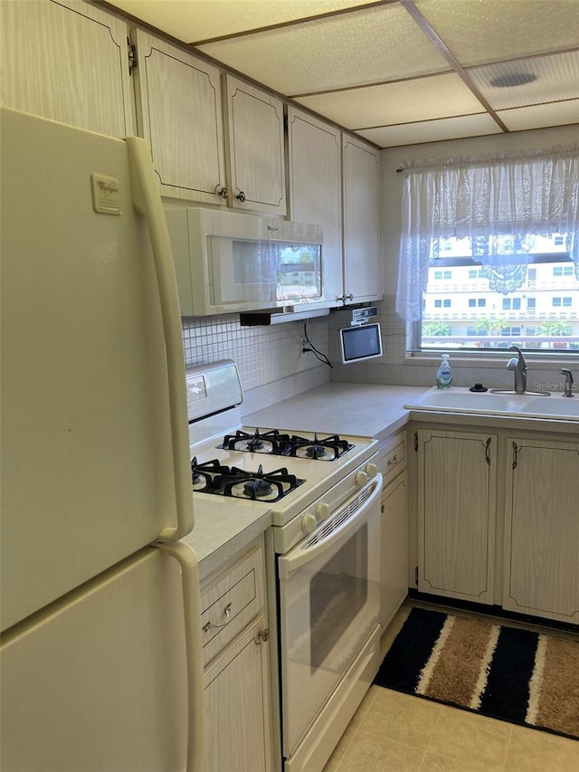 5623 80th St N Unit 314, Saint Petersburg, FL 33709 - kitchen with white appliances, light countertops, decorative backsplash, and light tile patterned flooring