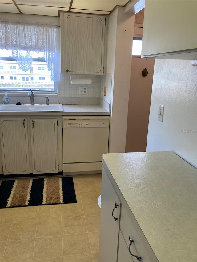 5623 80th St N Unit 314, Saint Petersburg, FL 33709 - kitchen with dishwasher, light tile patterned floors, light countertops, and tasteful backsplash