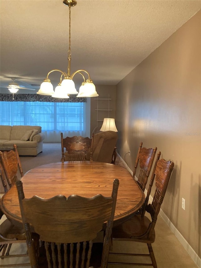 5623 80th St N Unit 314, Saint Petersburg, FL 33709 - tiled dining space featuring a textured ceiling and a chandelier