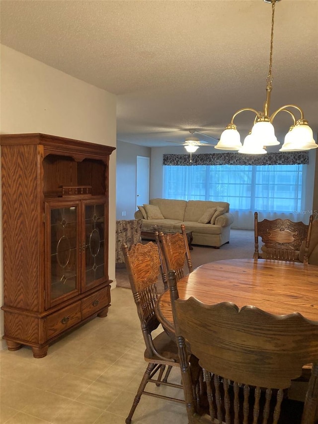 5623 80th St N Unit 314, Saint Petersburg, FL 33709 - dining space with a textured ceiling and a chandelier