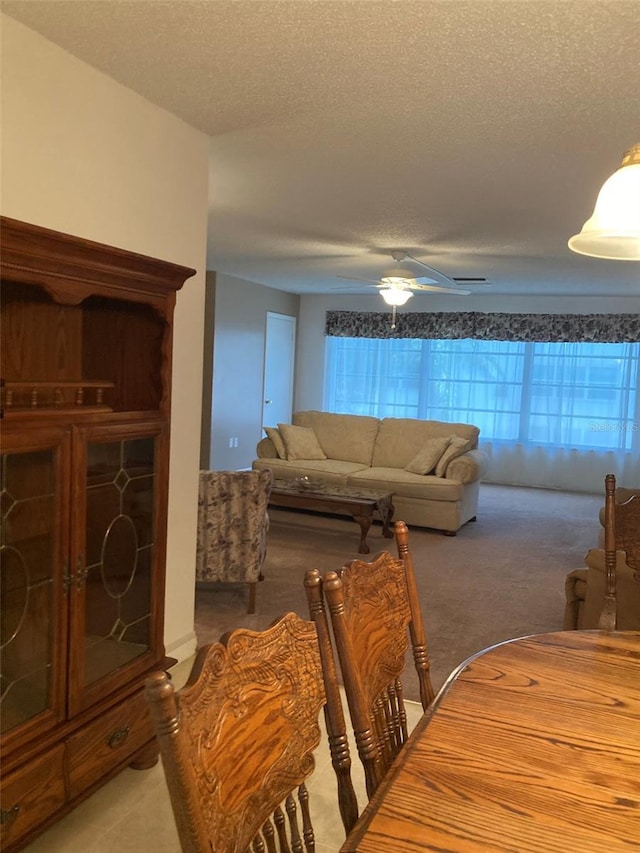 5623 80th St N Unit 314, Saint Petersburg, FL 33709 - dining area with a textured ceiling, light colored carpet, and a ceiling fan