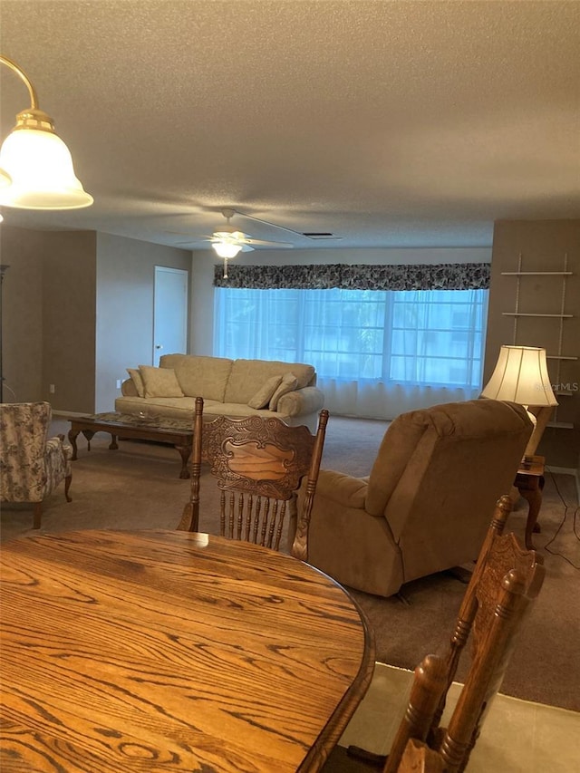 5623 80th St N Unit 314, Saint Petersburg, FL 33709 - living area featuring a textured ceiling, carpet, and ceiling fan
