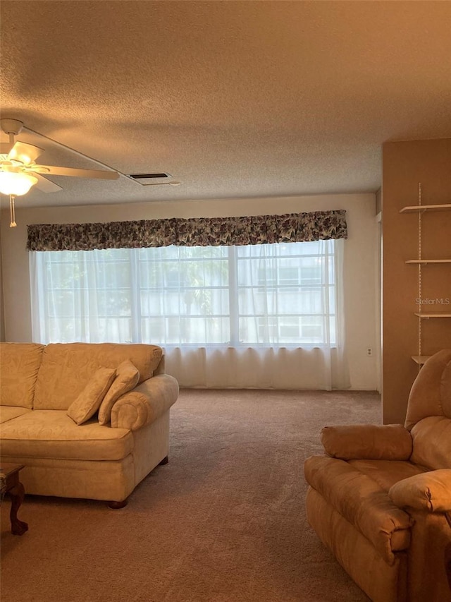 5623 80th St N Unit 314, Saint Petersburg, FL 33709 - carpeted living room featuring a textured ceiling and a ceiling fan