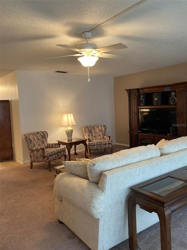 5623 80th St N Unit 314, Saint Petersburg, FL 33709 - living room featuring light carpet, ceiling fan, and a textured ceiling