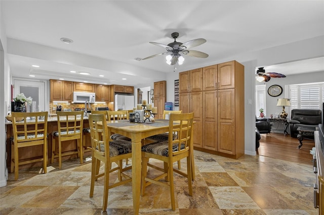 210 Jayview Ave, Lehigh Acres, FL 33936 - dining space with a ceiling fan, light stone finish flooring, and recessed lighting