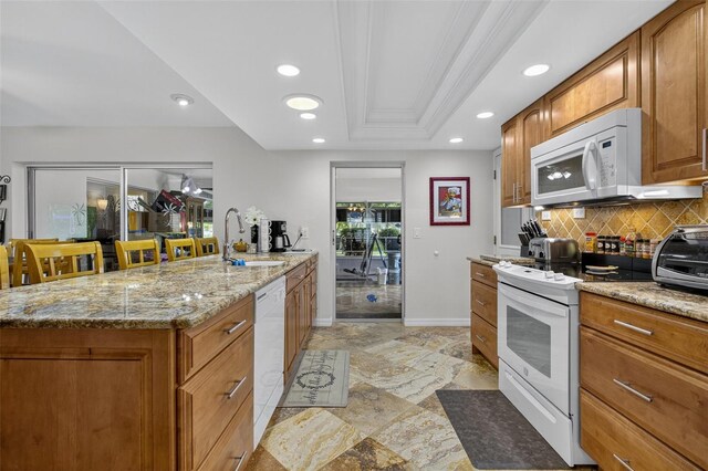 210 Jayview Ave, Lehigh Acres, FL 33936 - kitchen featuring white appliances, decorative backsplash, brown cabinetry, recessed lighting, and light stone counters