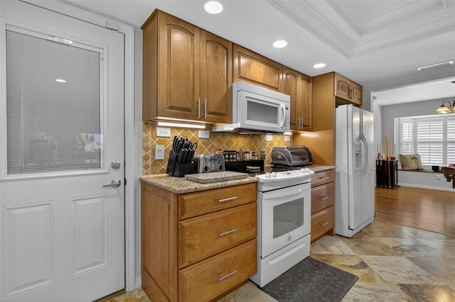 210 Jayview Ave, Lehigh Acres, FL 33936 - kitchen with white appliances, ornamental molding, tasteful backsplash, brown cabinetry, and recessed lighting