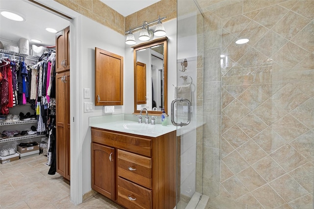 210 Jayview Ave, Lehigh Acres, FL 33936 - full bathroom featuring vanity, a stall shower, and a spacious closet