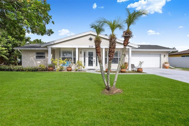 210 Jayview Ave, Lehigh Acres, FL 33936 - view of front facade with stucco siding, an attached garage, driveway, and a front yard