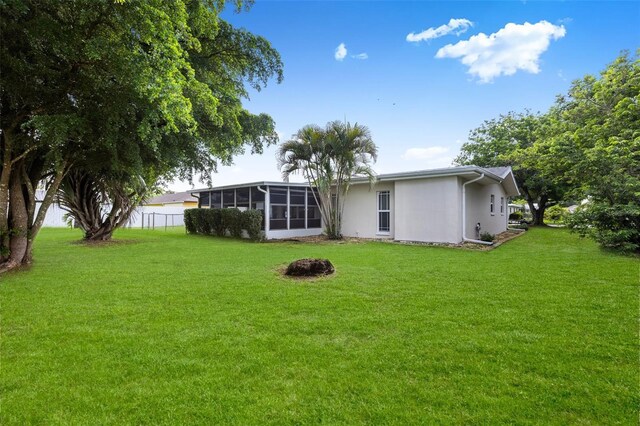 210 Jayview Ave, Lehigh Acres, FL 33936 - rear view of property featuring a sunroom and stucco siding