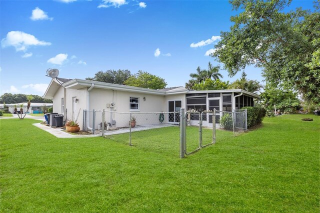210 Jayview Ave, Lehigh Acres, FL 33936 - back of house with a sunroom and stucco siding