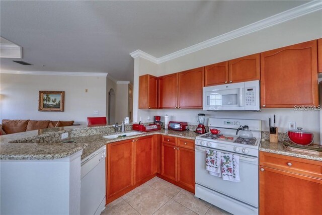 2733 Via Cipriani Unit 830B, Clearwater, FL 33764 - kitchen with white appliances, crown molding, open floor plan, light stone counters, and a peninsula