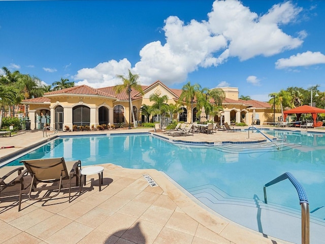 2733 Via Cipriani Unit 830B, Clearwater, FL 33764 - community pool featuring a patio area