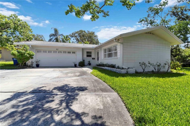 917 Pineview Ave, Clearwater, FL 33756 - ranch-style house with a front lawn, an attached garage, and concrete driveway