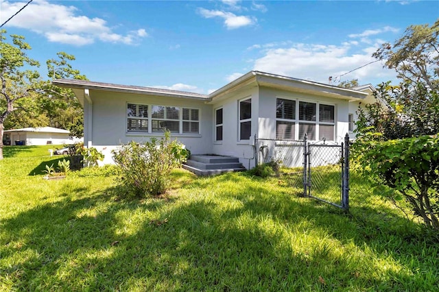 917 Pineview Ave, Clearwater, FL 33756 - rear view of property featuring stucco siding and a gate