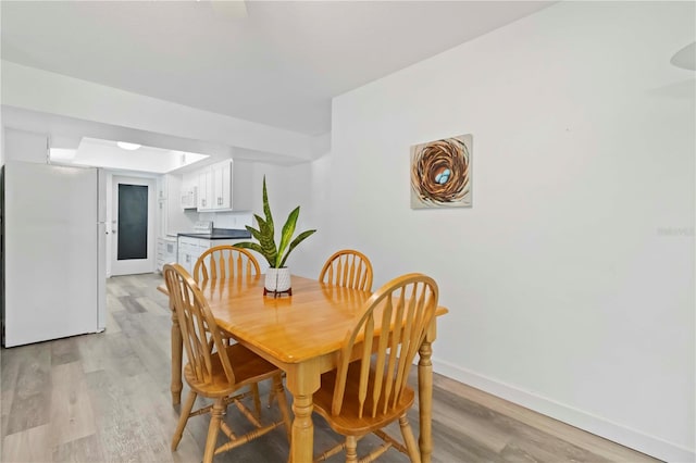 917 Pineview Ave, Clearwater, FL 33756 - dining space featuring light wood-style flooring and baseboards