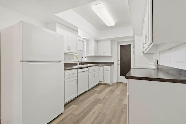 917 Pineview Ave, Clearwater, FL 33756 - kitchen with white appliances, dark countertops, white cabinetry, and light wood finished floors