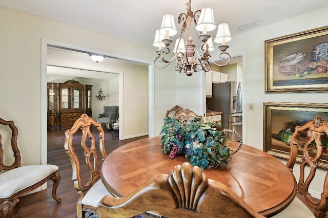 6642 Parson Brown Dr, Orlando, FL 32819 - dining room with a chandelier, dark wood-style flooring, and a textured ceiling