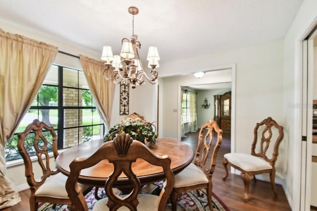 6642 Parson Brown Dr, Orlando, FL 32819 - dining area featuring a chandelier and wood finished floors