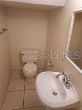 14442 Reuter Strasse Cir Unit 812, Tampa, FL 33613 - half bath featuring toilet and tile patterned floors