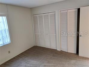 14442 Reuter Strasse Cir Unit 812, Tampa, FL 33613 - unfurnished bedroom featuring two closets
