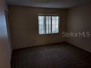 14442 Reuter Strasse Cir Unit 812, Tampa, FL 33613 - empty room featuring dark colored carpet