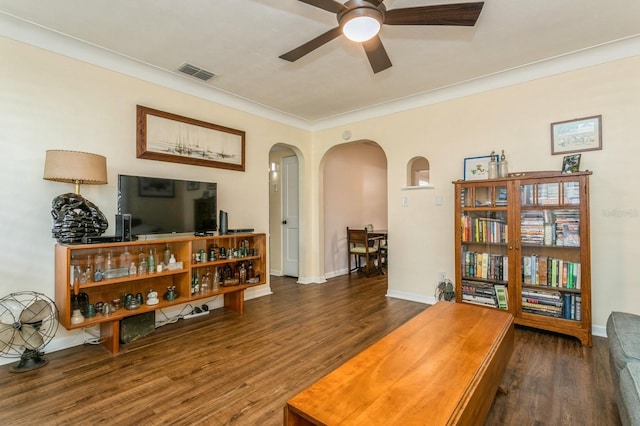 8014 27th Ave N, Saint Petersburg, FL 33710 - living room featuring arched walkways, ceiling fan, wood finished floors, and crown molding