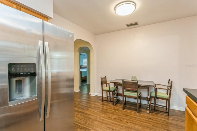 8014 27th Ave N, Saint Petersburg, FL 33710 - kitchen with stainless steel fridge with ice dispenser, arched walkways, and wood finished floors