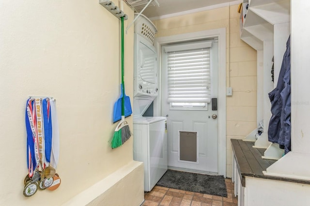 8014 27th Ave N, Saint Petersburg, FL 33710 - laundry area featuring stacked washing machine and dryer, brick patterned floors, and crown molding