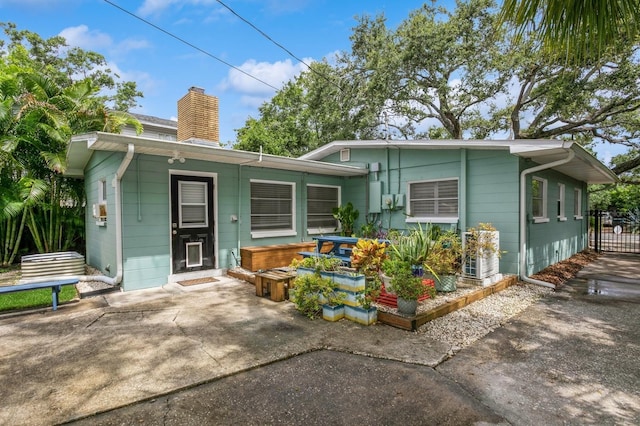 8014 27th Ave N, Saint Petersburg, FL 33710 - view of front of house featuring a chimney and a patio area