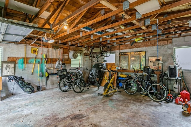 8014 27th Ave N, Saint Petersburg, FL 33710 - garage featuring concrete block wall and a garage door opener