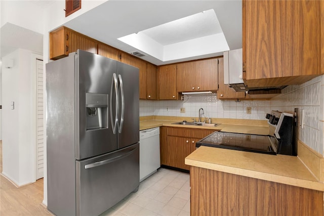 441 75th Ave N, Saint Petersburg, FL 33702 - kitchen with stainless steel refrigerator with ice dispenser, dishwasher, black / electric stove, a tray ceiling, and decorative backsplash
