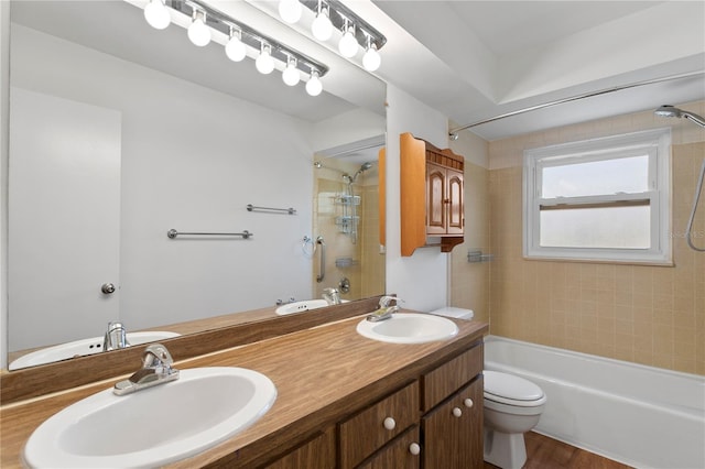 441 75th Ave N, Saint Petersburg, FL 33702 - full bath with shower / tub combination, double vanity, and wood finished floors