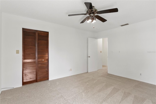 441 75th Ave N, Saint Petersburg, FL 33702 - unfurnished bedroom featuring light colored carpet, a closet, and ceiling fan