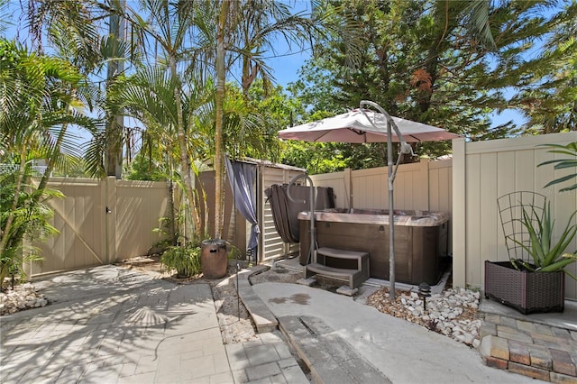 441 75th Ave N, Saint Petersburg, FL 33702 - fenced backyard with a hot tub, a patio, and a gate