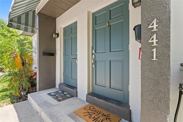 441 75th Ave N, Saint Petersburg, FL 33702 - doorway to property with stucco siding