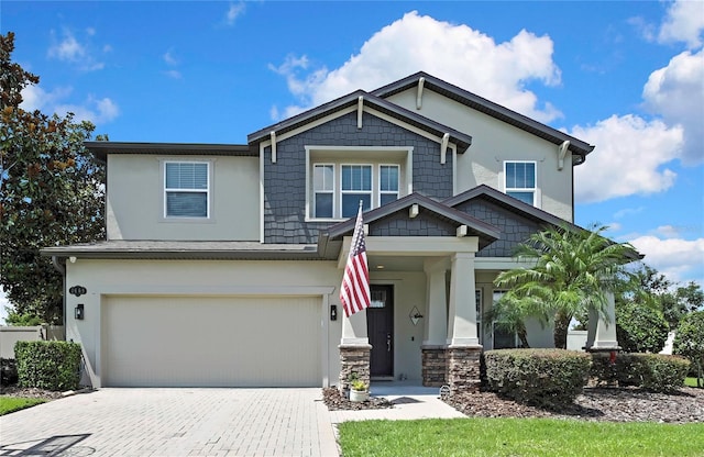 1669 Feather Grass Loop, Lutz, FL 33558 - craftsman-style home featuring a garage, decorative driveway, and stucco siding