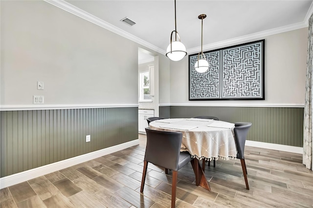 1669 Feather Grass Loop, Lutz, FL 33558 - dining space with a wainscoted wall, ornamental molding, and wood finished floors