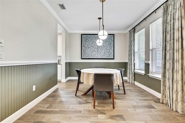 1669 Feather Grass Loop, Lutz, FL 33558 - dining space with wainscoting, ornamental molding, and light wood-type flooring